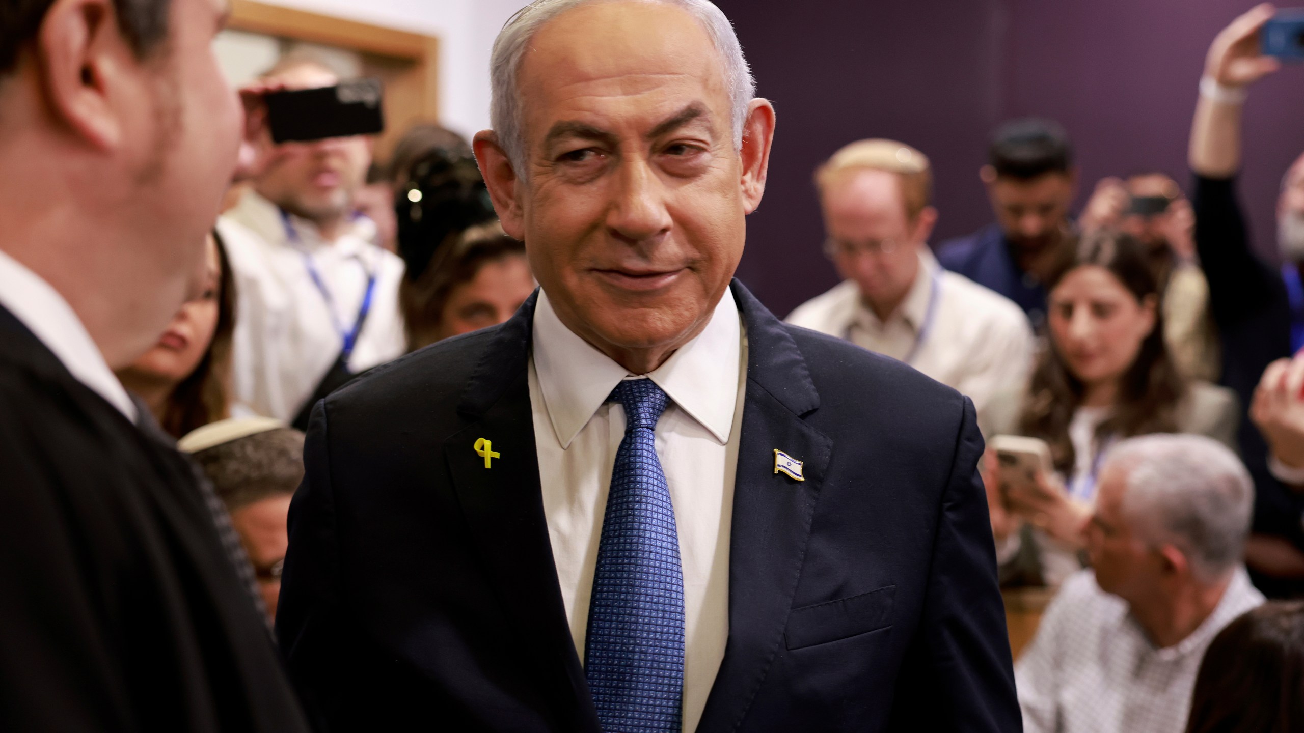 Israeli Prime Minister Benjamin Netanyahu arrives at the district court in Tel Aviv for his long-running trial for alleged corruption, in Tel Aviv, Israel, Tuesday, Dec. 10, 2024. (Menahem Kahana/Pool Photo via AP)