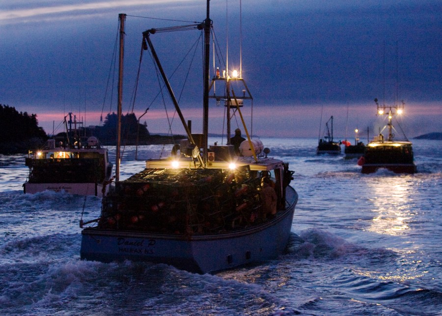 FILE — Fishing boats carrying lobster traps leave the harbor in West Dover Nova Scotia, Nov. 30, 2009. (AP Photo/The Canadian Press, Andrew Vaughan, File)