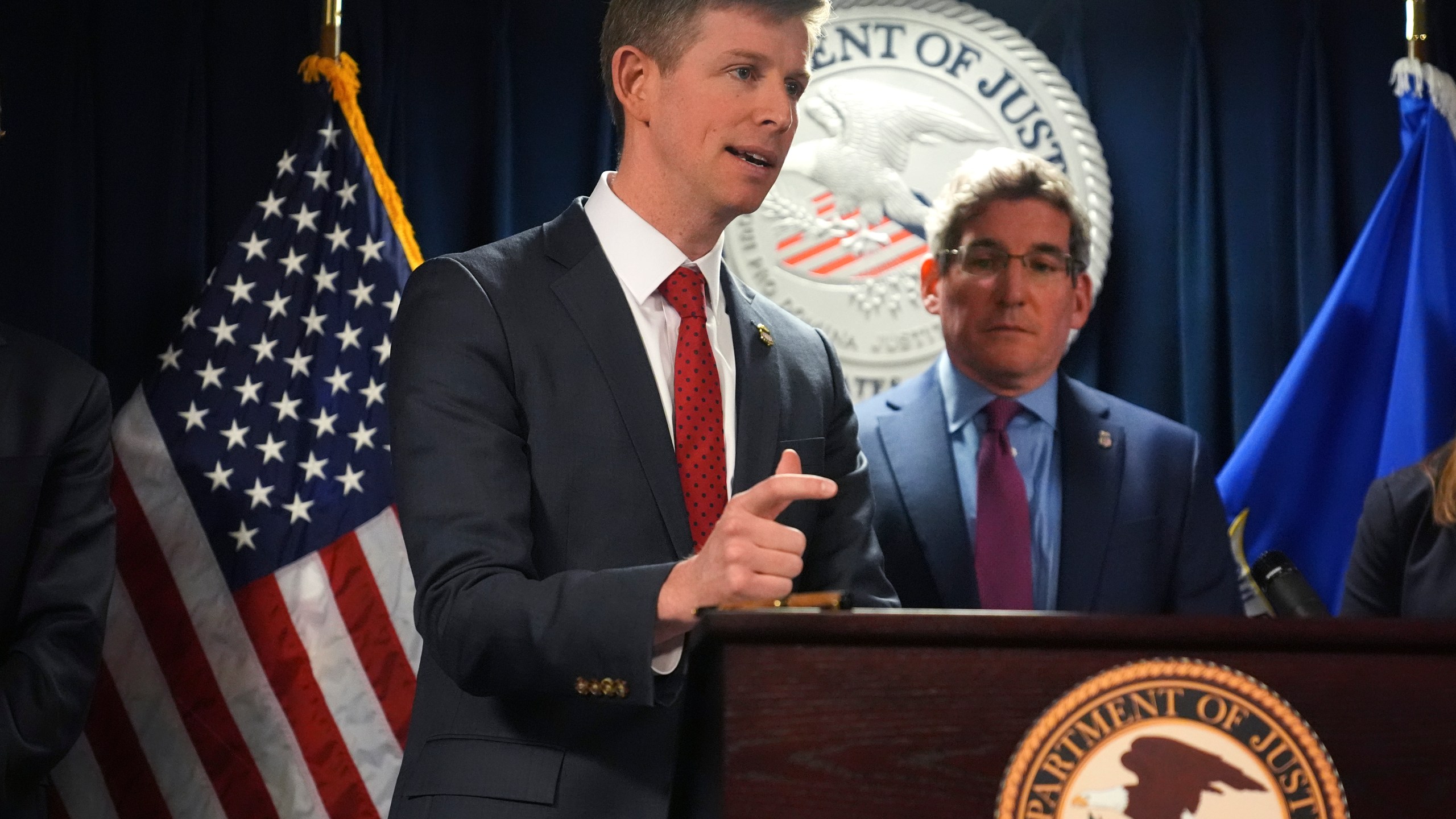 Christopher R. Kavanaugh, the United States Attorney for the Western District of Virginia, gestures while announcing that the McKinsey & Company agreed to pay $650 million for helping Purdue Pharma boost opioid sales during a news conference at the Moakley Federal Courthouse, Friday, Dec. 13, 2024, in Boston. At right is Joshua S. Levy, the United States Attorney for the District of Massachusetts. (AP Photo/Charles Krupa)