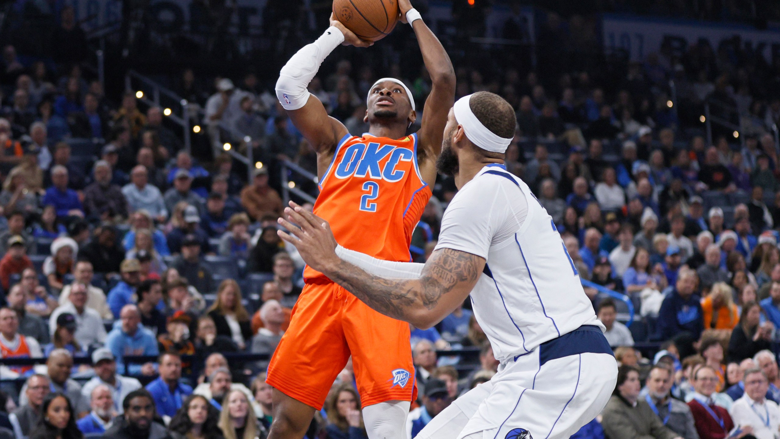 Oklahoma City Thunder guard Shai Gilgeous-Alexander (2) shoots against Dallas Mavericks center Daniel Gafford, right, during the first half of an Emirates NBA Cup basketball game, Tuesday, Dec. 10, 2024, in Oklahoma City. (AP Photo/Nate Billings)