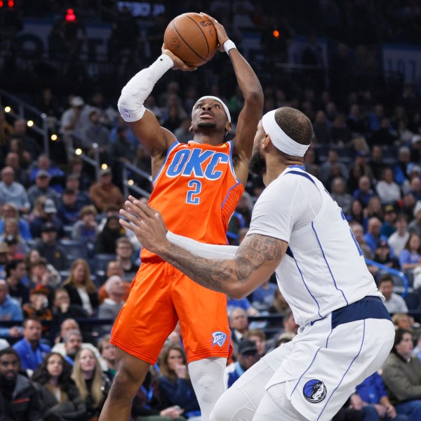 Oklahoma City Thunder guard Shai Gilgeous-Alexander (2) shoots against Dallas Mavericks center Daniel Gafford, right, during the first half of an Emirates NBA Cup basketball game, Tuesday, Dec. 10, 2024, in Oklahoma City. (AP Photo/Nate Billings)