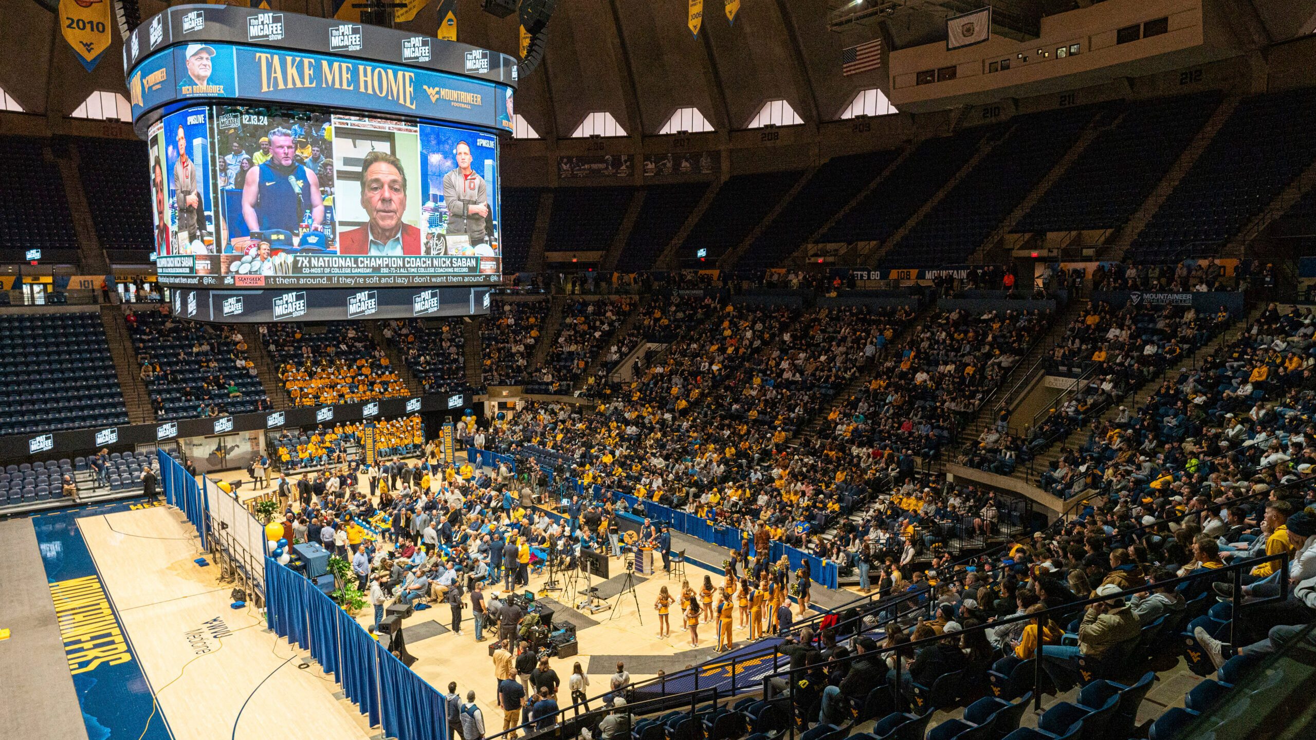 Fans fill the arena during an introductory NCAA college football news conference for West Virginia coach Rich Rodriguez, Friday, Dec. 13, 2024, in Morgantown, W.Va. (Benjamin Powell/The Dominion-Post via AP)