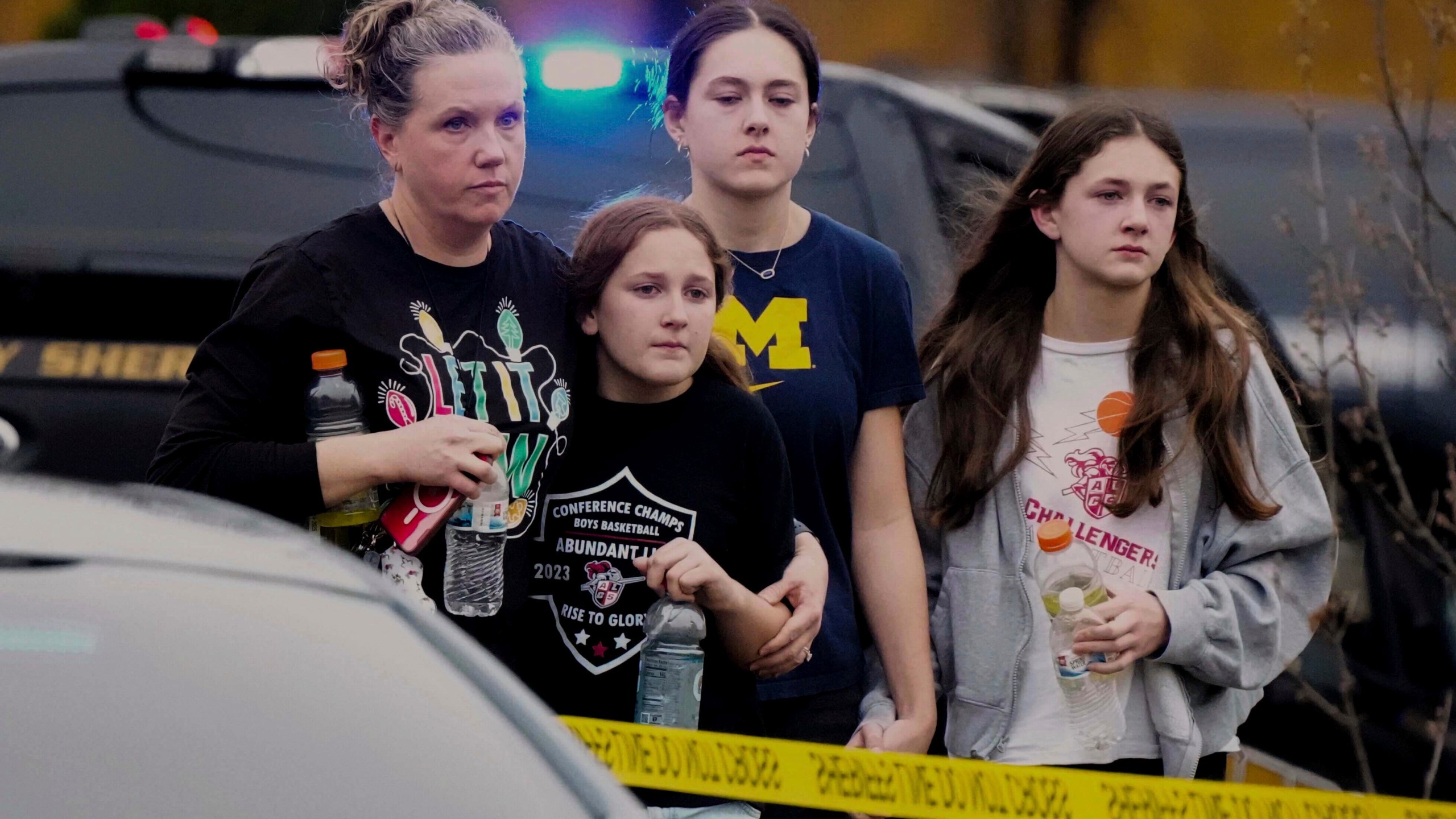 A family leaves the shelter after multiple injuries were reported following a shooting at the Abundant Life Christian School, Monday, Dec. 16, 2024. (AP Photo/Morry Gash)