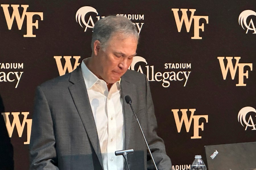 Dave Clawson becomes emotional explaining his decision to resign as head football coach at Wake Forest, Tuesday, Dec. 17, 2024, during an during an NCAA college football news conference in Winston-Salem, N.C. (AP Photo/Aaron Beard)