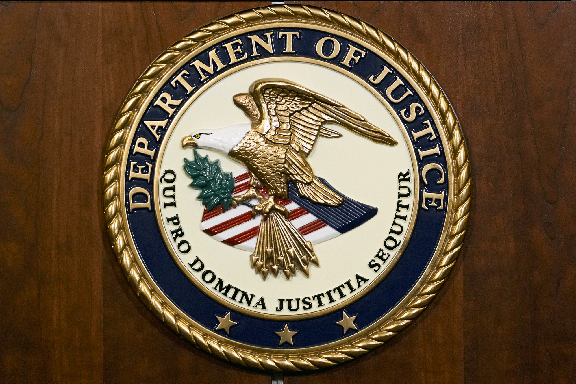 FILE - The seal of the Department of Justice is pictured, Aug. 1, 2023, in Washington. The U.S. government will pay nearly $116 million to resolve lawsuits brought by more than 100 women who say they were abused or mistreated at a now-shuttered federal prison in California that was known as the “rape club” because of rampant staff-on-inmate sexual misconduct. (AP Photo/J. Scott Applewhite, File)