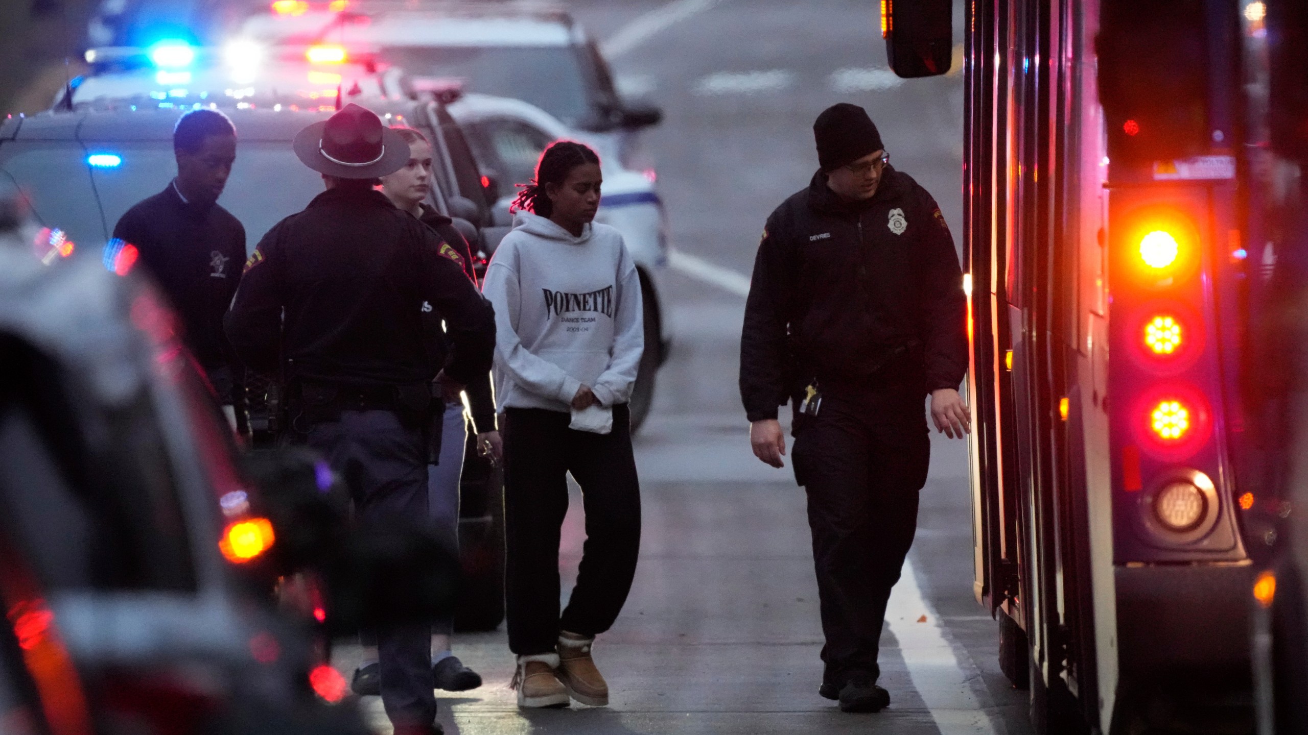 Students aboard a bus as they leave the shelter following a shooting at the Abundant Life Christian School, Monday, Dec. 16, 2024. (AP Photo/Morry Gash)