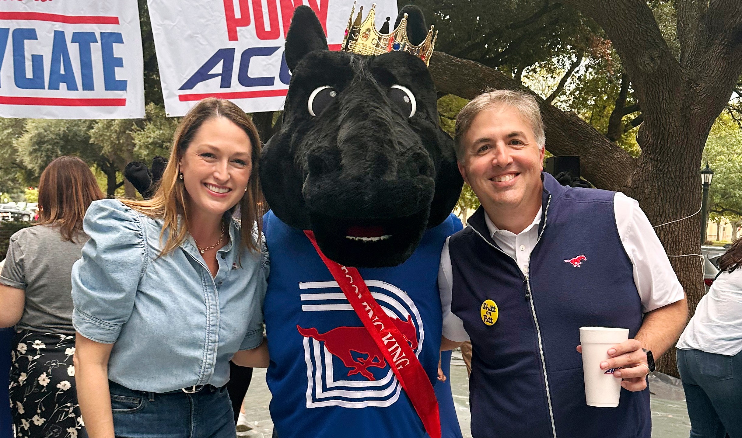 In this image provided by Lily Howard, Laura Howard, left, and Will Howard pose with SMU mascot Peruna during a tailgate event, Saturday, Nov. 2, 2024, prior to an NCAA college football game in Dallas. (Lily Howard via AP)