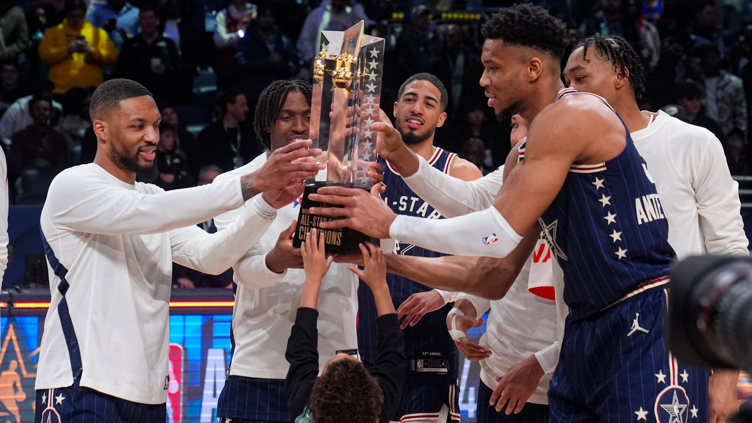 FILE - The East team, lead by captain Milwaukee Bucks forward Giannis Antetokounmpo, right, hoists the trophy after defeating the West 211-186 in the NBA All-Star basketball game in Indianapolis, Sunday, Feb. 18, 2024. (AP Photo/Darron Cummings, File)