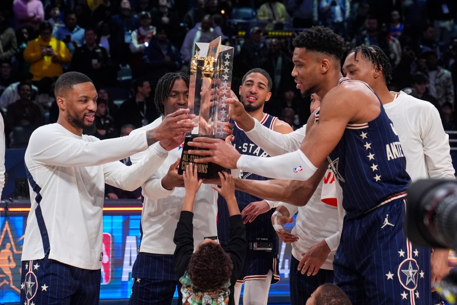 FILE - The East team, lead by captain Milwaukee Bucks forward Giannis Antetokounmpo, right, hoists the trophy after defeating the West 211-186 in the NBA All-Star basketball game in Indianapolis, Sunday, Feb. 18, 2024. (AP Photo/Darron Cummings, File)