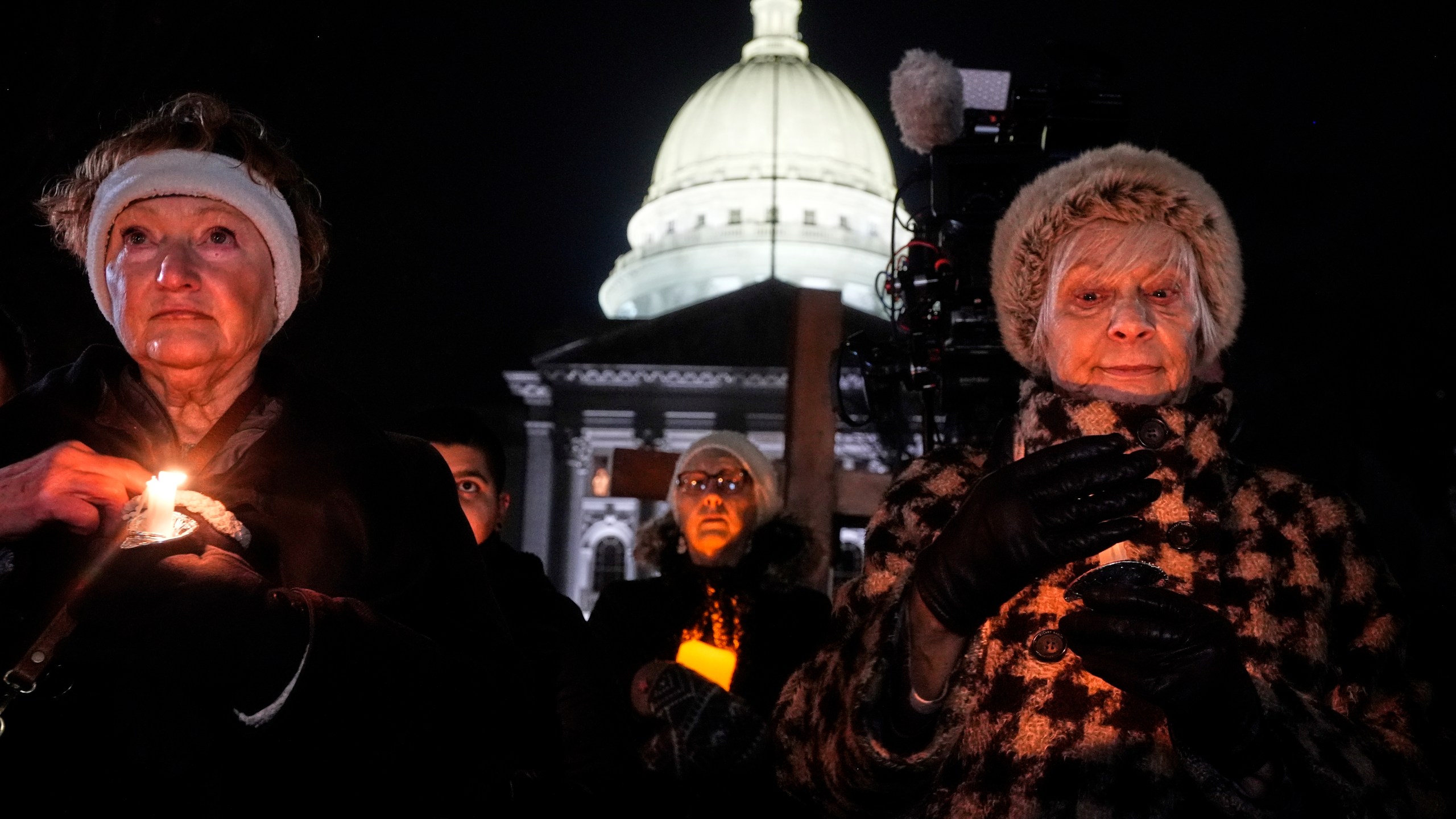 Supporters hold candles during a candlelight vigil Tuesday, Dec. 17, 2024, outside the Wisconsin Capitol in Madison, Wis., following a shooting at the Abundant Life Christian School on Monday, Dec. 16. (AP Photo/Morry Gash)