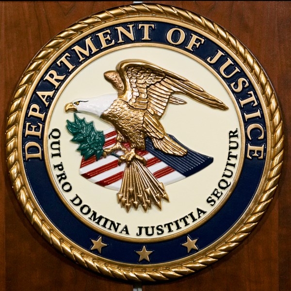 FILE - The seal of the Department of Justice is pictured, Aug. 1, 2023, in Washington. The U.S. government will pay nearly $116 million to resolve lawsuits brought by more than 100 women who say they were abused or mistreated at a now-shuttered federal prison in California that was known as the “rape club” because of rampant staff-on-inmate sexual misconduct. (AP Photo/J. Scott Applewhite, File)