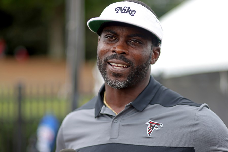 FILE - Former Atlanta Falcons quarterback Michael Vick speaks to members of the media during NFL football training camp at the team's practice facility in Flowery Branch, Ga., Wednesday, Aug. 10, 2022. (Jason Getz/Atlanta Journal-Constitution via AP, File)/Atlanta Journal-Constitution via AP)