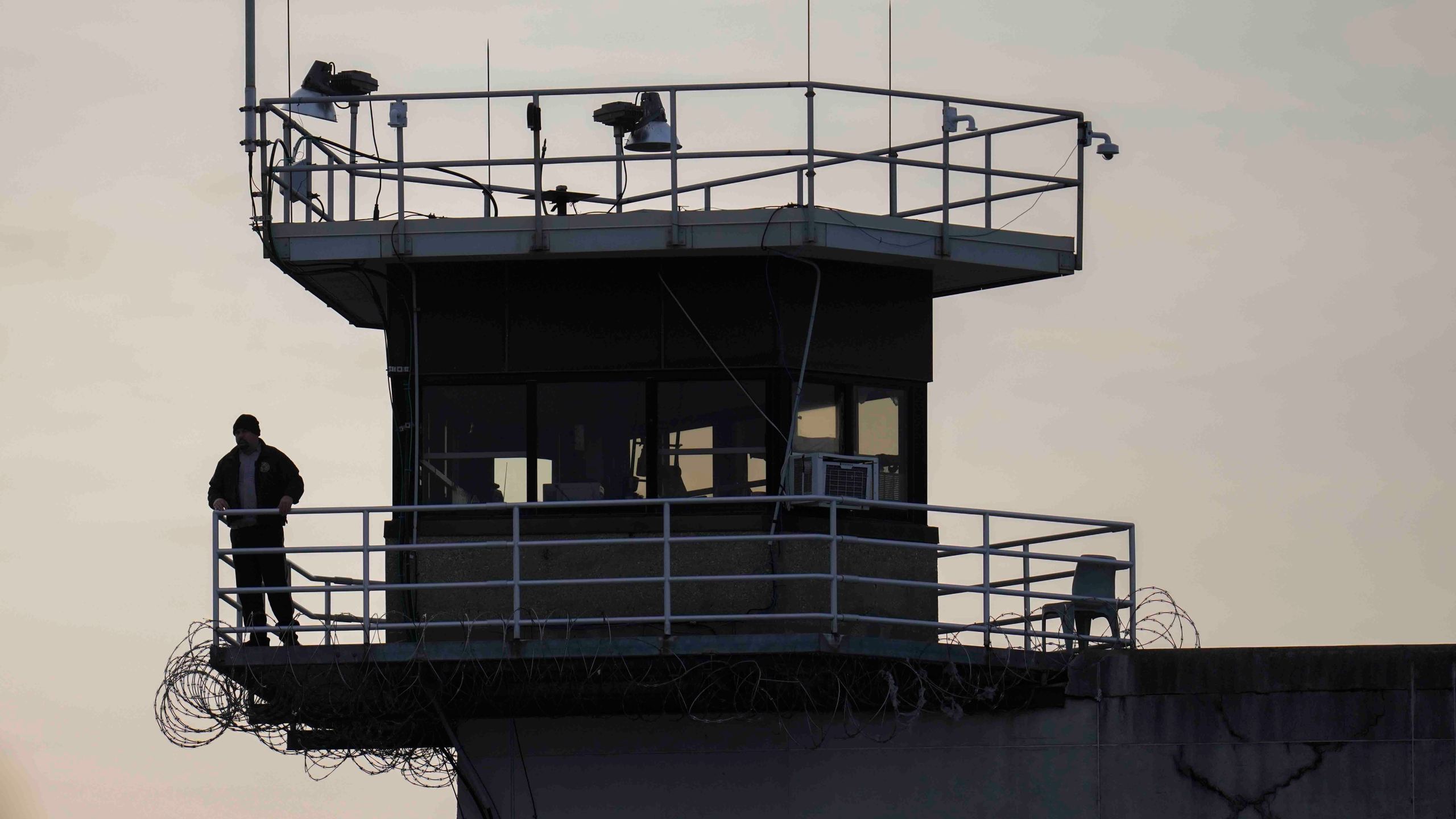 A guard stands in a tower at Indiana State Prison on Tuesday, Dec. 17, 2024, in Michigan City, Ind., where, barring last-minute court action or intervention by Gov. Eric Holcomb, Joseph Corcoran, 49, convicted in the 1997 killings of his brother and three other people, is scheduled to be put to death by lethal injection before sunrise Wednesday, Dec. 18. (AP Photo/Erin Hooley)