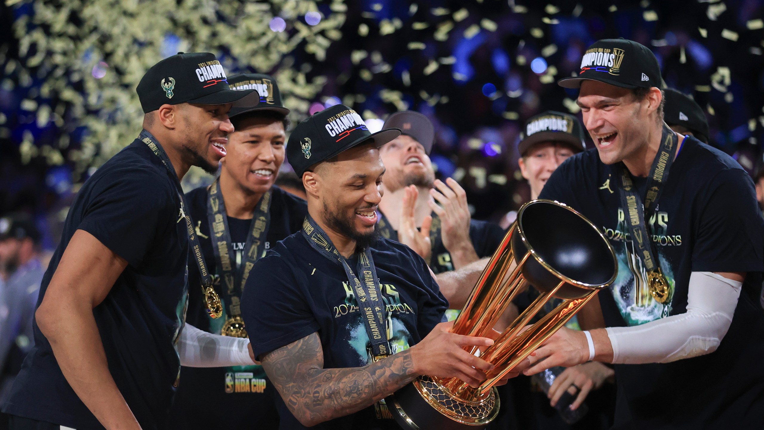 Milwaukee Bucks forward Giannis Antetokounmpo (34), Milwaukee Bucks guard Damian Lillard (0), and Milwaukee Bucks center Brook Lopez (11) celebrate after their team's victory in the championship game of the NBA Cup basketball tournament against the Oklahoma City Thunder Tuesday, Dec. 17, 2024, in Las Vegas. (AP Photo/Ian Maule)