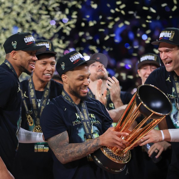 Milwaukee Bucks forward Giannis Antetokounmpo (34), Milwaukee Bucks guard Damian Lillard (0), and Milwaukee Bucks center Brook Lopez (11) celebrate after their team's victory in the championship game of the NBA Cup basketball tournament against the Oklahoma City Thunder Tuesday, Dec. 17, 2024, in Las Vegas. (AP Photo/Ian Maule)