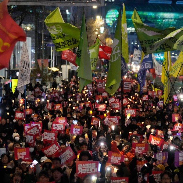 FILE - Protesters march to the presidential office after a candlelight vigil against South Korean President Yoon Suk Yeol in Seoul, South Korea, Dec. 5, 2024. (AP Photo/Ahn Young-joon, File)