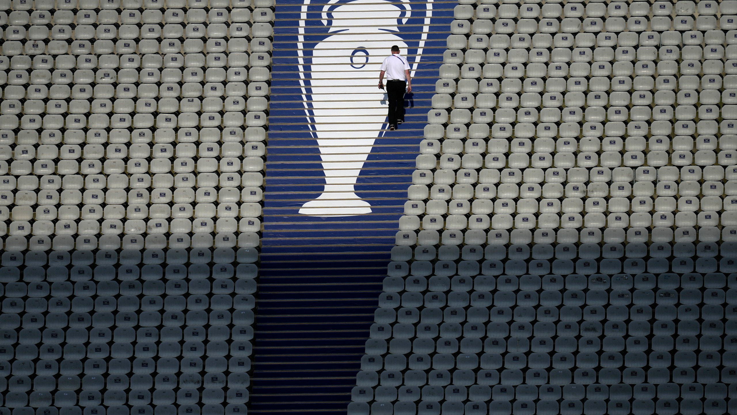 FILE - A security official walks past a Champions League trophy logo during an Inter Milan training session at the Ataturk Olympic Stadium in Istanbul, Turkey, Friday, June 9, 2023. (AP Photo/Thanassis Stavrakis, File)