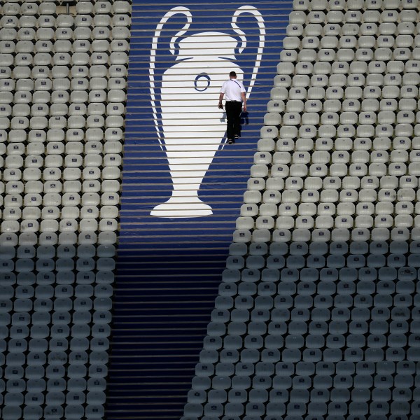 FILE - A security official walks past a Champions League trophy logo during an Inter Milan training session at the Ataturk Olympic Stadium in Istanbul, Turkey, Friday, June 9, 2023. (AP Photo/Thanassis Stavrakis, File)