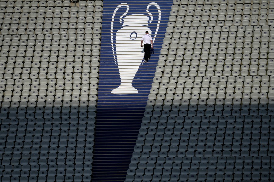 FILE - A security official walks past a Champions League trophy logo during an Inter Milan training session at the Ataturk Olympic Stadium in Istanbul, Turkey, Friday, June 9, 2023. (AP Photo/Thanassis Stavrakis, File)