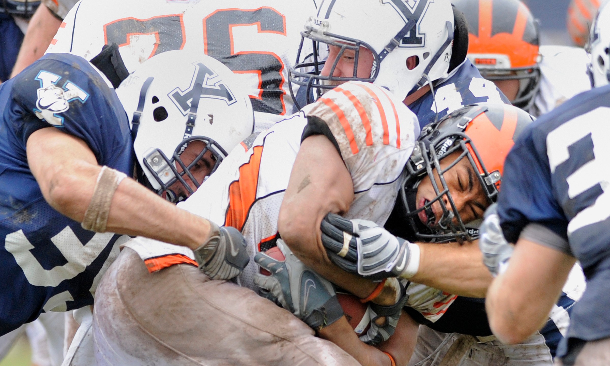 FILE - Princeton's Jordan Culbreath, center, fights for an extra yard as he is tackled by Yale's Jay Pilkerton, left, Bobby Abare, center, and Brady Hart, right during Yale's 14-0 victory in an NCAA college football game in New Haven, Conn., on Saturday, Nov. 15, 2008. (AP Photo/Fred Beckham, File)