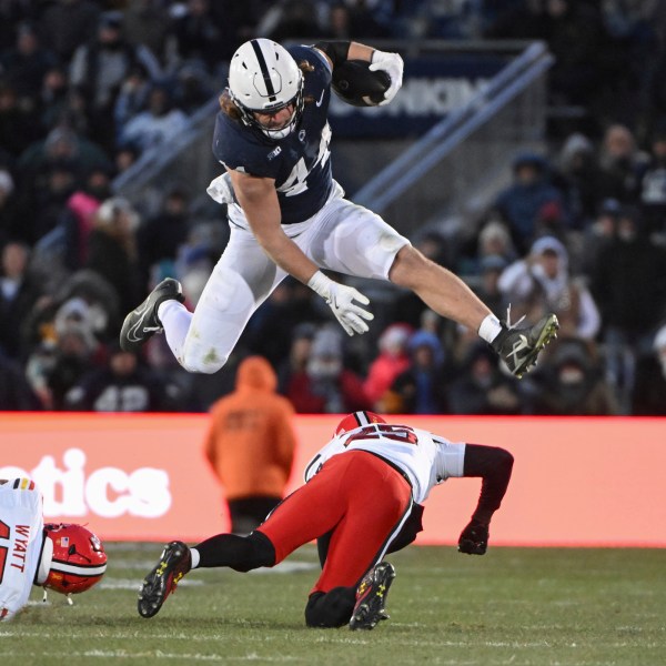 FILE - Penn State tight end Tyler Warren (44) hurdles Maryland defensive back Kevis Thomas (25) during the second quarter of an NCAA college football game, Saturday, Nov. 30, 2024, in State College, Pa. (AP Photo/Barry Reeger, File)