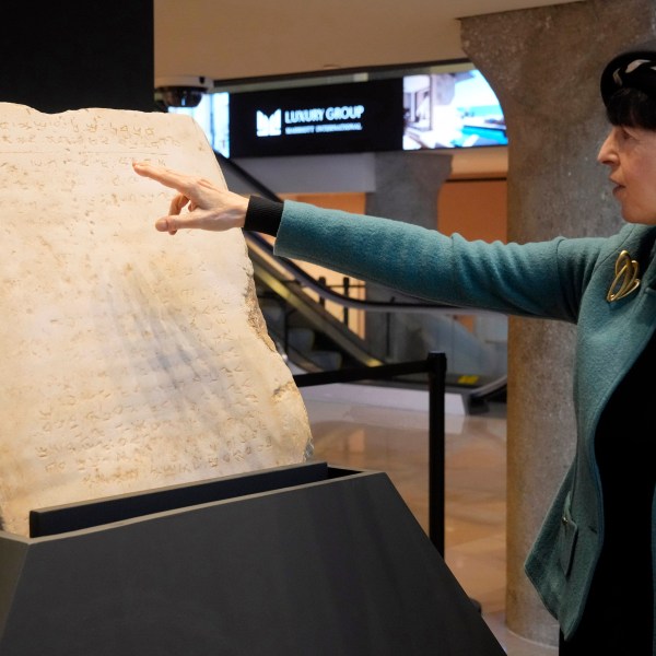 Sharon Liberman Mintz, Sotheby's Judaica Specialist, Books & Manuscripts, discusses the oldest complete tablet of the Ten Commandments, weighing 115-pounds and approximately 1,500 years old, that is displayed at Sotheby's, in New York, Monday, Dec. 9, 2024, where it is to be offered for auction in a single lot sale, Dec, 18, 2024. (AP Photo/Richard Drew)