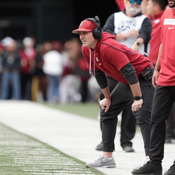 FILE - Washington State head coach Jake Dickert, center, watches the first half of an NCAA college football game, Saturday, Oct. 19, 2024, in Pullman, Wash. (AP Photo/Young Kwak, File)