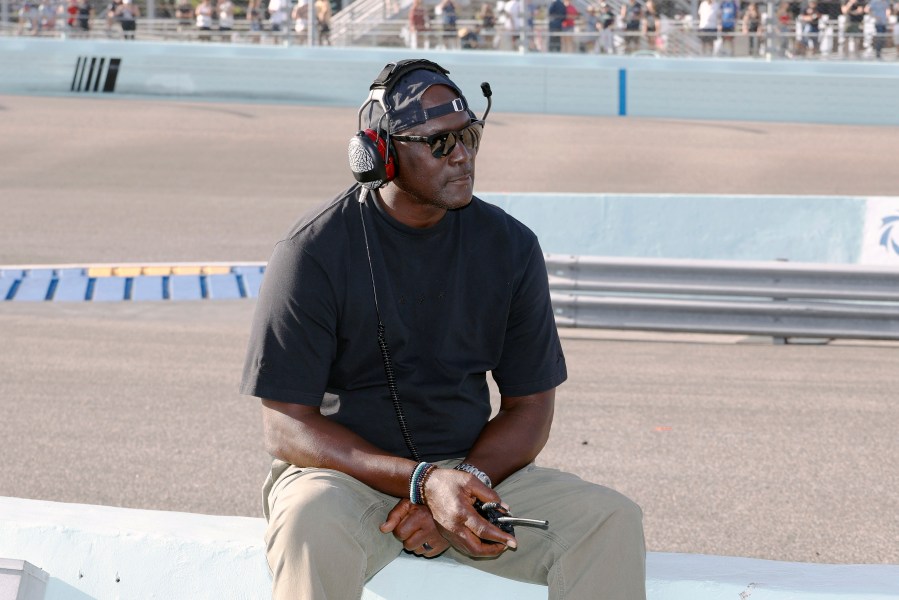 FILE - Car owner Michael Jordan watches from the pits during a NASCAR Cup Series auto race at Homestead-Miami Speedway in Homestead, Fla., Oct. 27, 2024. (AP Photo/Terry Renna, File)