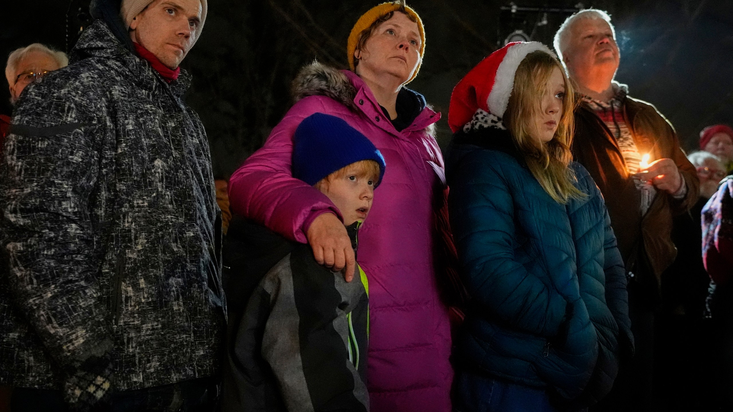 Supporters hold candles during a candlelight vigil Tuesday, Dec. 17, 2024, outside the Wisconsin Capitol in Madison, Wis., following a shooting at the Abundant Life Christian School on Monday, Dec. 16. (AP Photo/Morry Gash)