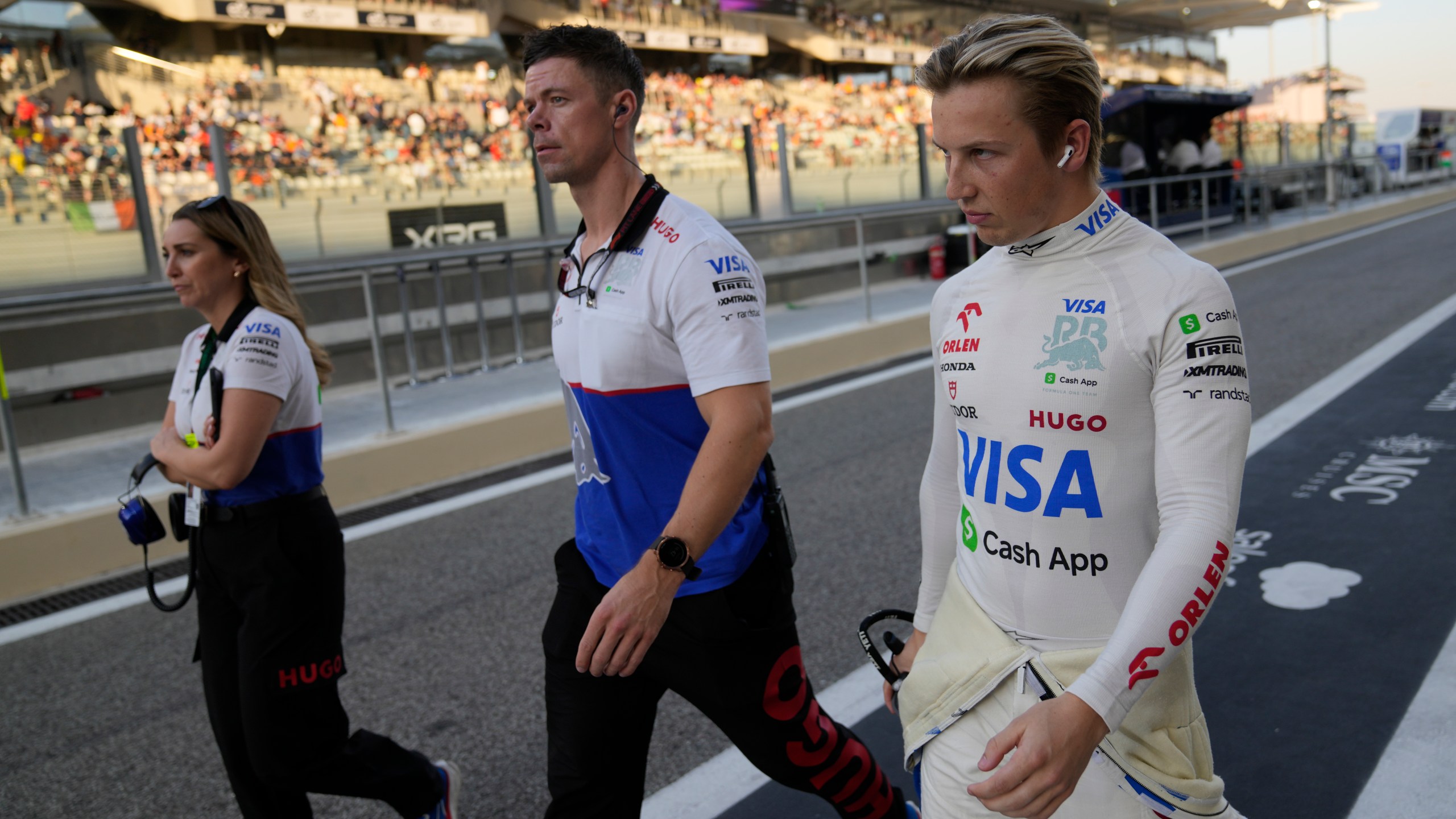 RB driver Liam Lawson of New Zealand walks in the pit lane before the Formula One Abu Dhabi Grand Prix at the Yas Marina Circuit in Abu Dhabi, UAE, Sunday, Dec. 8, 2024. (AP Photo/Darko Bandic)