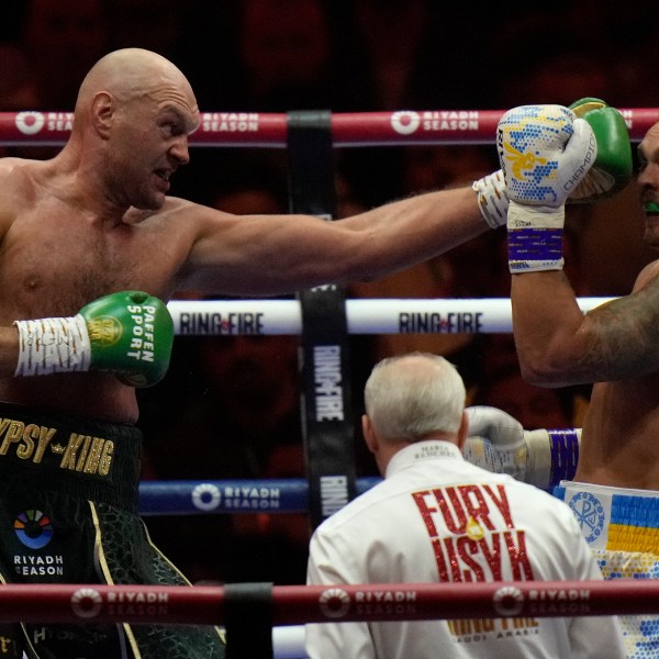 FILE - Britain's Tyson Fury, left, punches Ukraine's Oleksandr Usyk during their undisputed heavyweight world championship boxing fight at the Kingdom Arena in Riyadh, Saudi Arabia, May 19, 2024. (AP Photo/Francisco Seco, File)