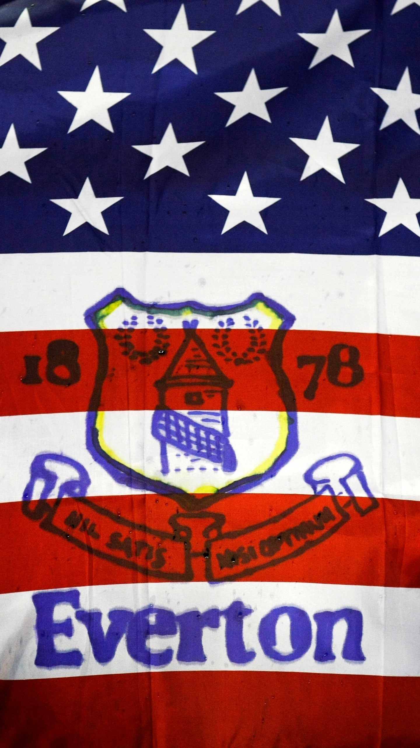 FILE - Fans hold a flag before the English Premier League soccer match between Everton and Bolton at Goodison Park, Liverpool, England, Wednesday Jan. 4, 2012. (AP Photo/Tim Hales, File)