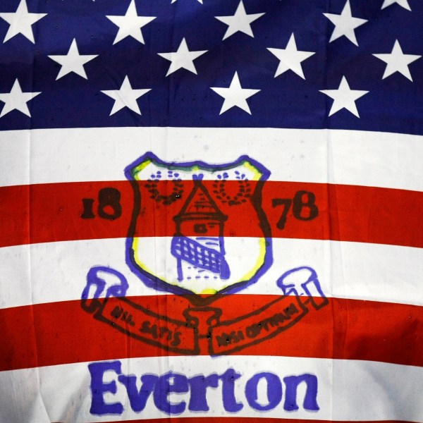 FILE - Fans hold a flag before the English Premier League soccer match between Everton and Bolton at Goodison Park, Liverpool, England, Wednesday Jan. 4, 2012. (AP Photo/Tim Hales, File)