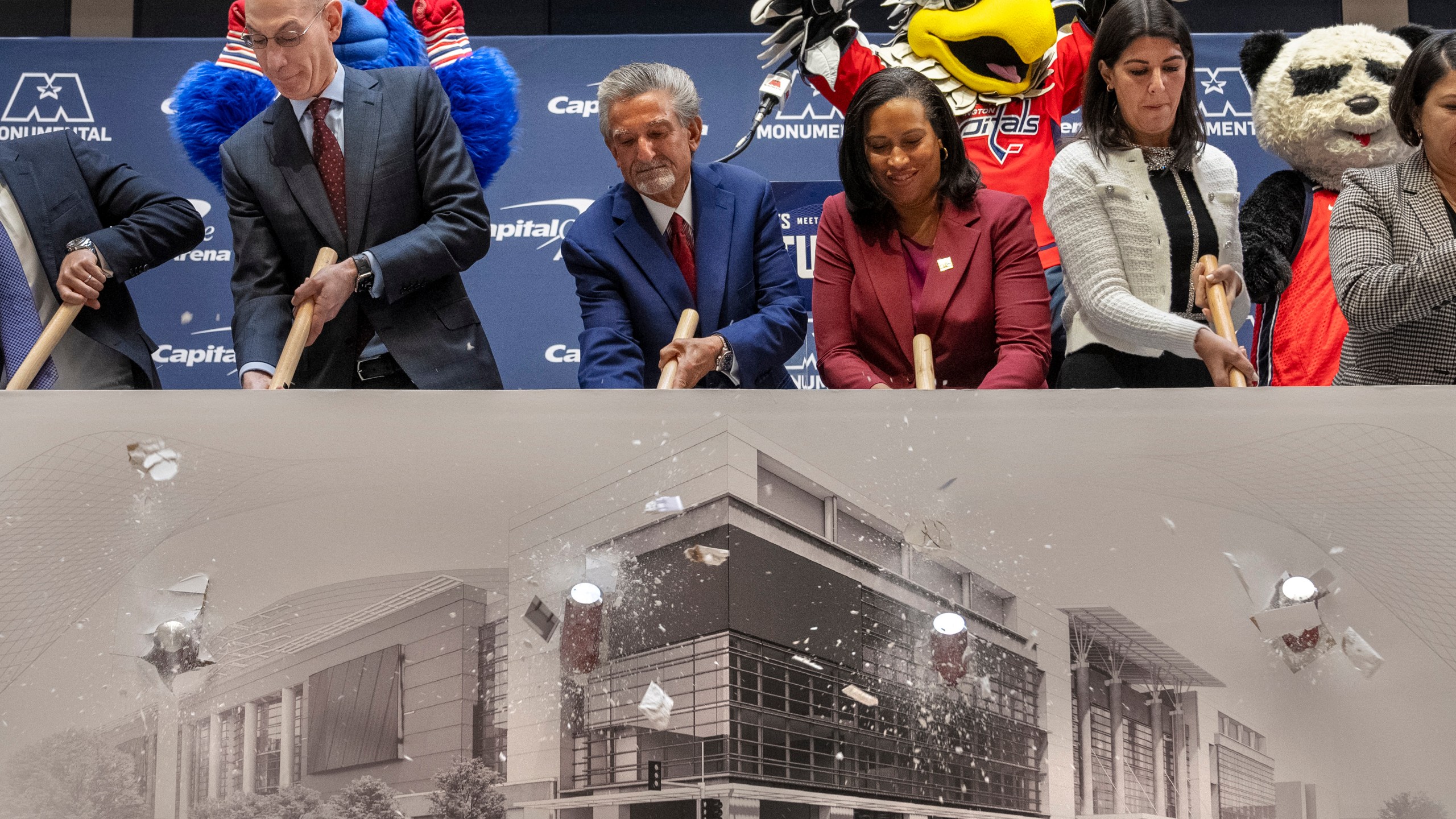 From left, NBA Commissioner Adam Silver, Ted Leonsis, owner of the Washington Wizards NBA basketball team and Washington Capitals NHL hockey team, Washington DC Mayor Muriel Bowser, and Washington DC Councilmember Brooke Pinto, sledgehammer through a printed piece of drywall during a ceremonial first swing of demolition, at an event announcing a new Capital One Arena Gallery Place Atrium, Thursday, Dec. 19, 2024, in Washington. (AP Photo/Jacquelyn Martin)