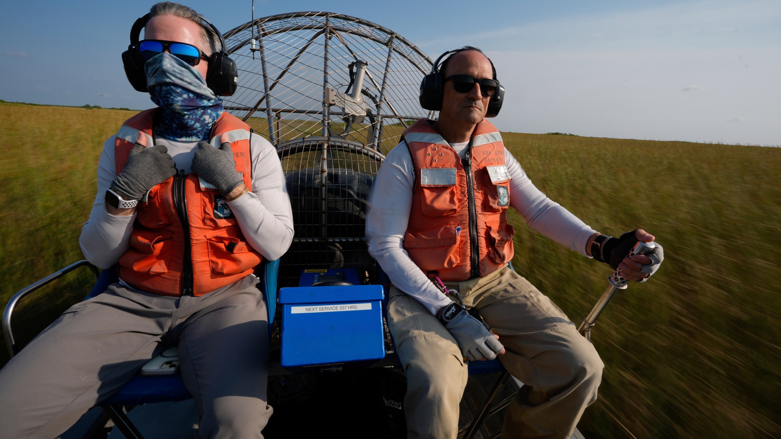 Florida International University professor John Kominoski, left, and research specialist Rafael Travieso travel by airboat through Shark River Slough on their way to collect water samples and maintain automatic sampling equipment in Florida's Everglades National Park, Tuesday, May 14, 2024. (AP Photo/Rebecca Blackwell)