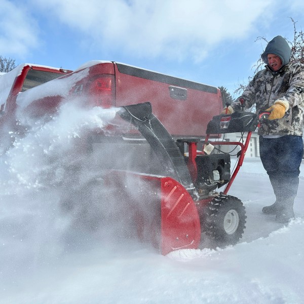 Jim Thom clears his driveway of snow with a snowblower on Thursday, Dec. 19, 2024, in Bismarck, N.D. (AP Photo/Jack Dura)