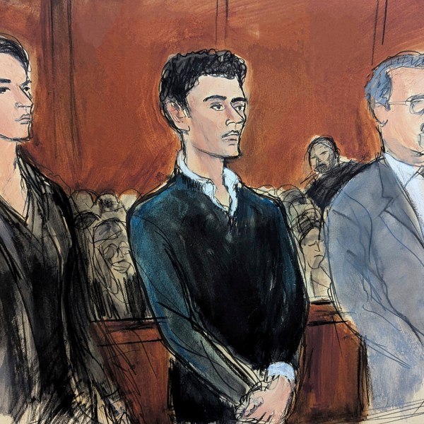 Luigi Mangione, center, stands flanked by his attorneys Karen Agnifilo, left and Marc Agnifilo, right, during his initial court appearance in Manhattan federal court, Thursday, Dec. 19, 2024, in New York. (Elizabeth Williams via AP)