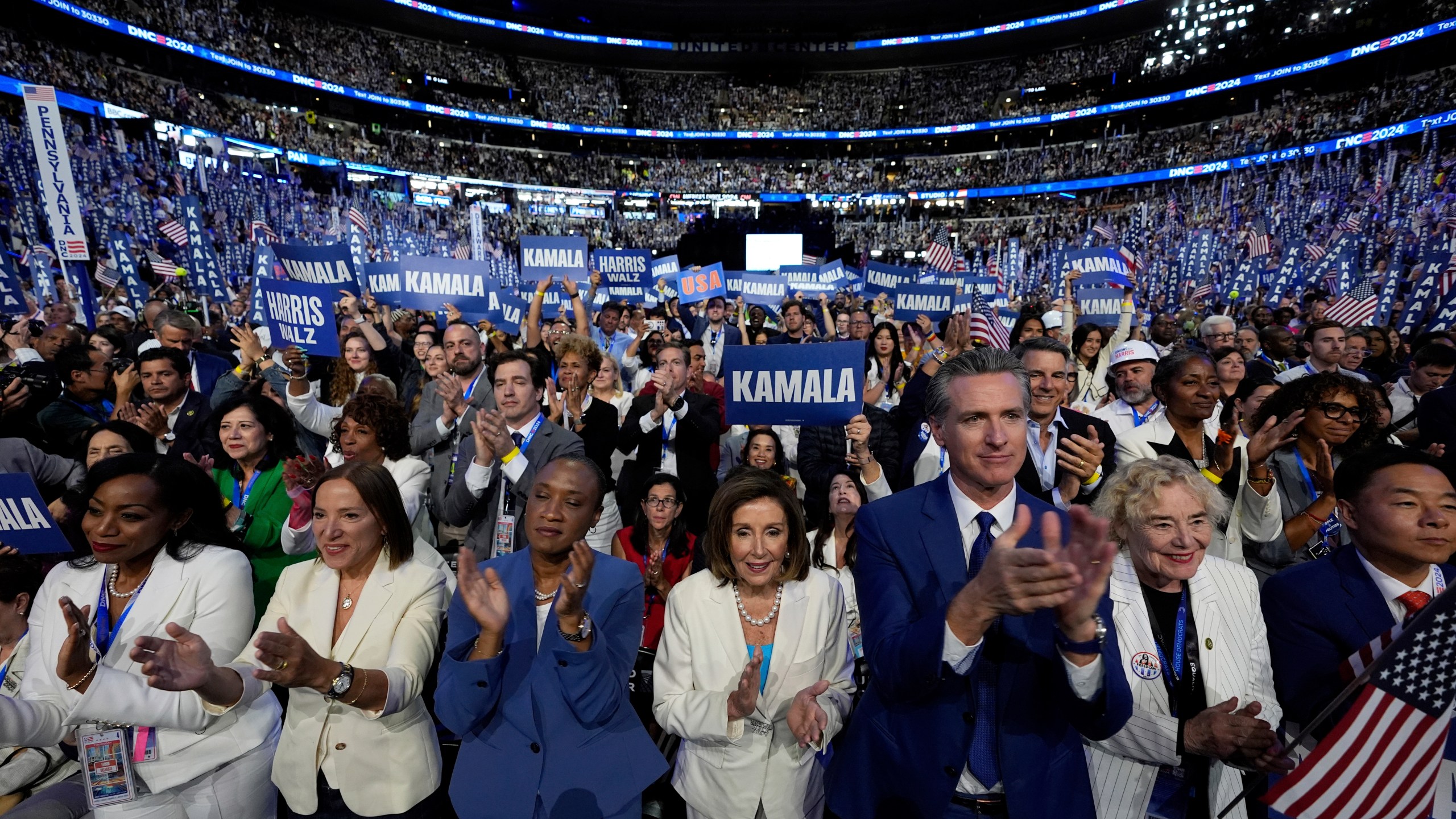 FILE - Rep. Nancy Pelosi, D-Calif., center, and California Gov. Gavin Newsom, center right, applaud as Democratic presidential nominee Vice President Kamala Harris speaks during the Democratic National Convention, in Chicago, Aug. 22, 2024. (AP Photo/Paul Sancya, File)