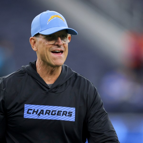 Los Angeles Chargers head coach Jim Harbaugh walks on the field before an NFL football game against the Denver Broncos, Thursday, Dec. 19, 2024, in Inglewood, Calif. (AP Photo/Ryan Sun)