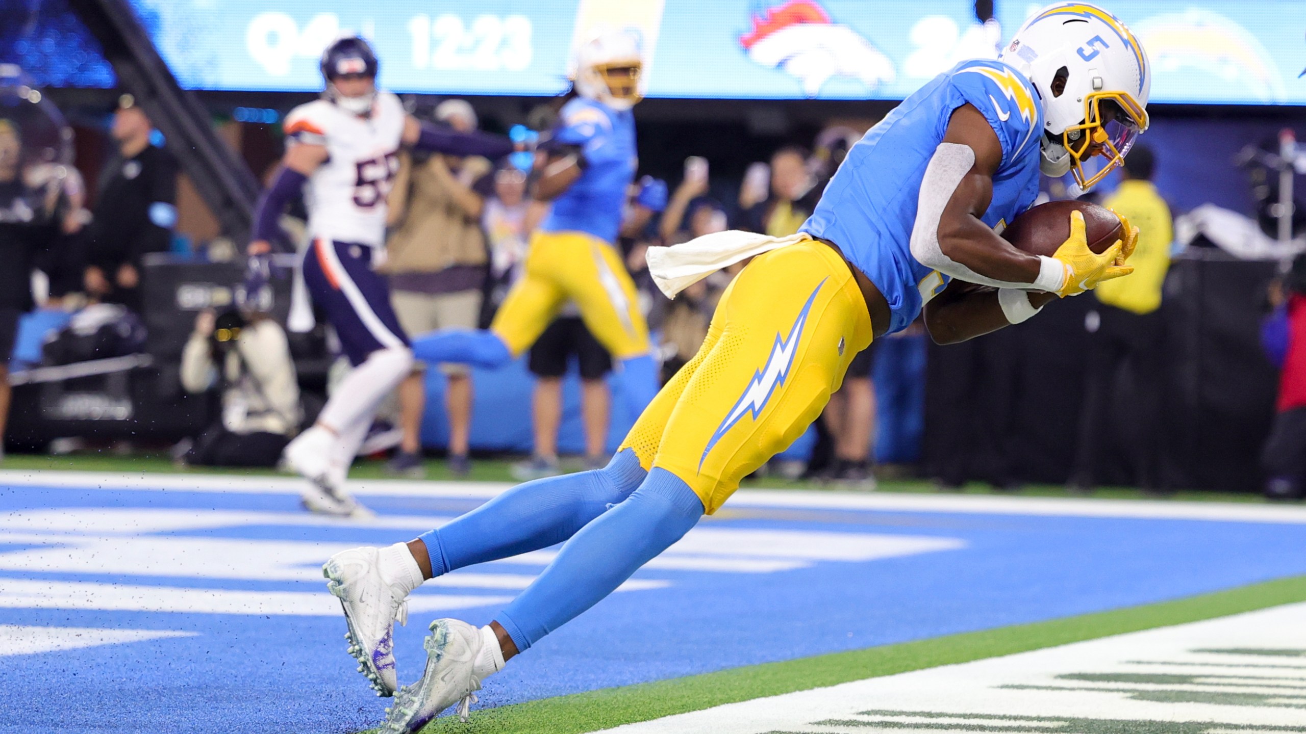 Los Angeles Chargers wide receiver Joshua Palmer (5) catches the ball in the end zone for a two-point conversion during the second half an NFL football game against the Denver Broncos, Thursday, Dec. 19, 2024, in Inglewood, Calif. (AP Photo/Ryan Sun)