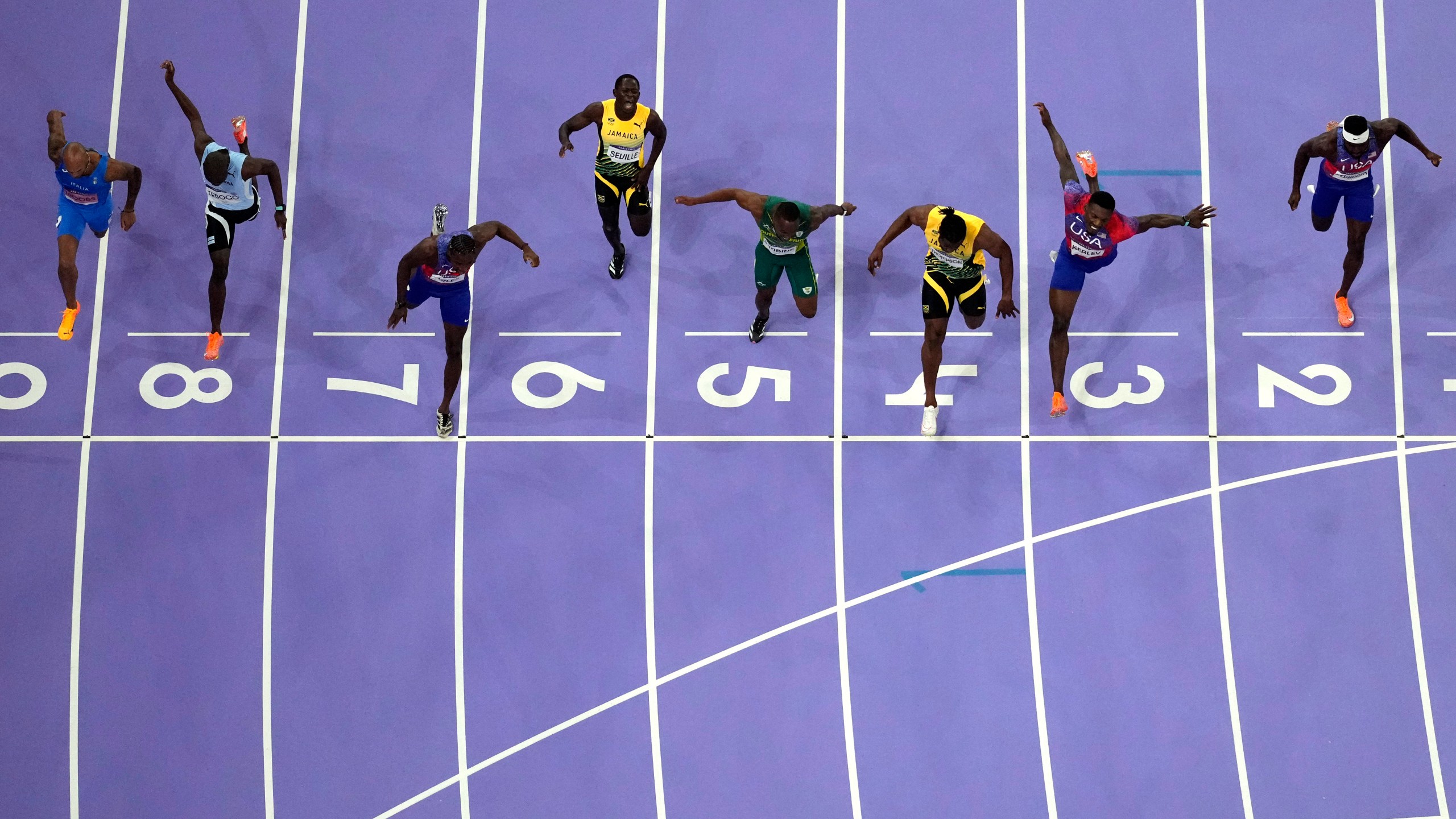 FILE - Noah Lyles, of the United States, in lane seven, wins the men's 100-meter final at the 2024 Summer Olympics, Sunday, Aug. 4, 2024, in Saint-Denis, France. (AP Photo/David J. Phillip, File)