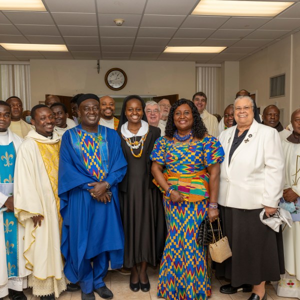 In this photo provided by Edem M. Adzokpa, Sister Seyram Mary Adzokpa, center, is surrounded by her fellow sisters, friends and family after making her first profession at the Sisters of the Holy Family in New Orleans on Thursday, Aug. 15, 2024. (Edem M. Adzokpa via AP)