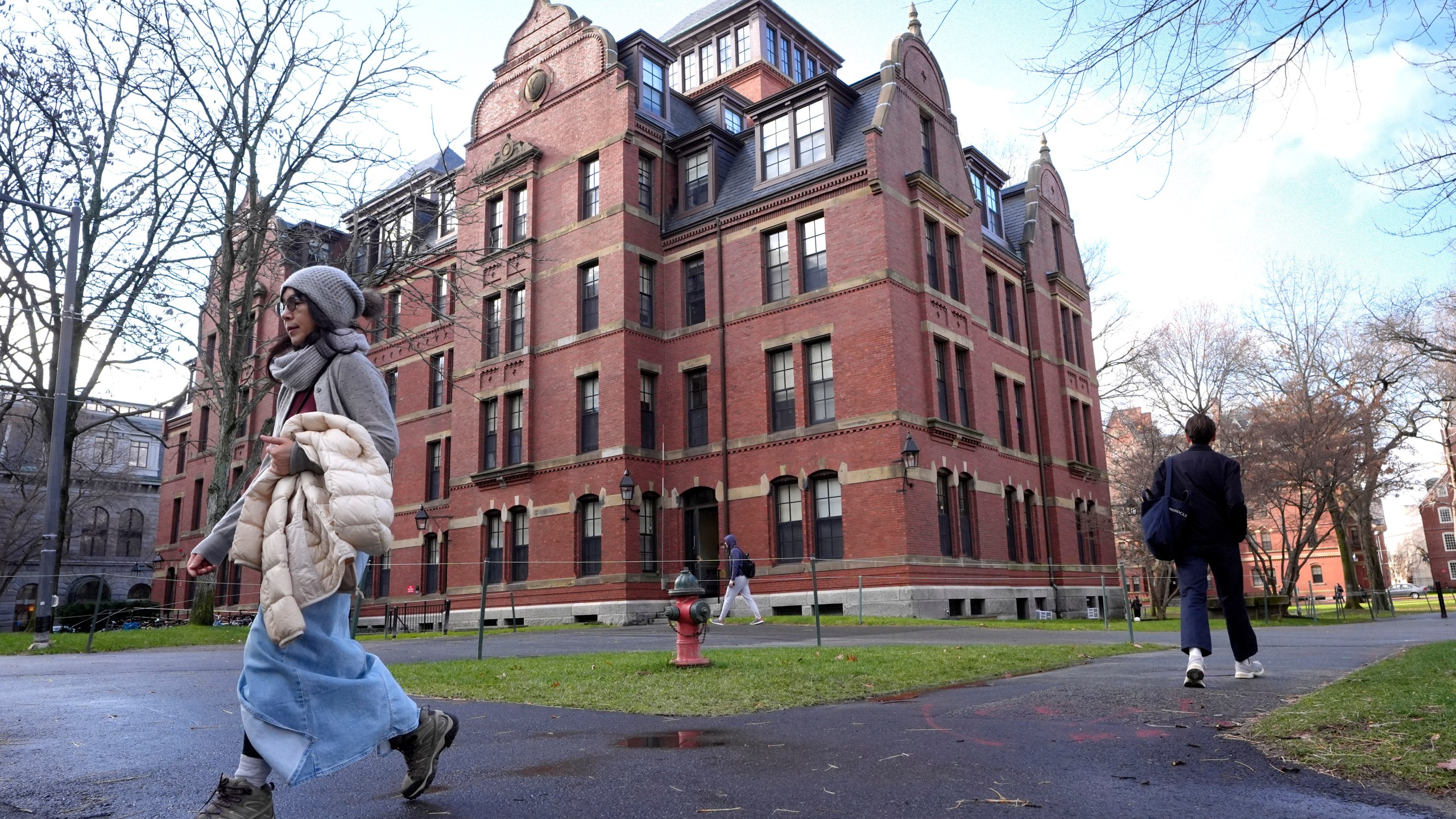 People walk between buildings, Tuesday, Dec. 17, 2024, on the campus of Harvard University in Cambridge, Mass. (AP Photo/Steven Senne)