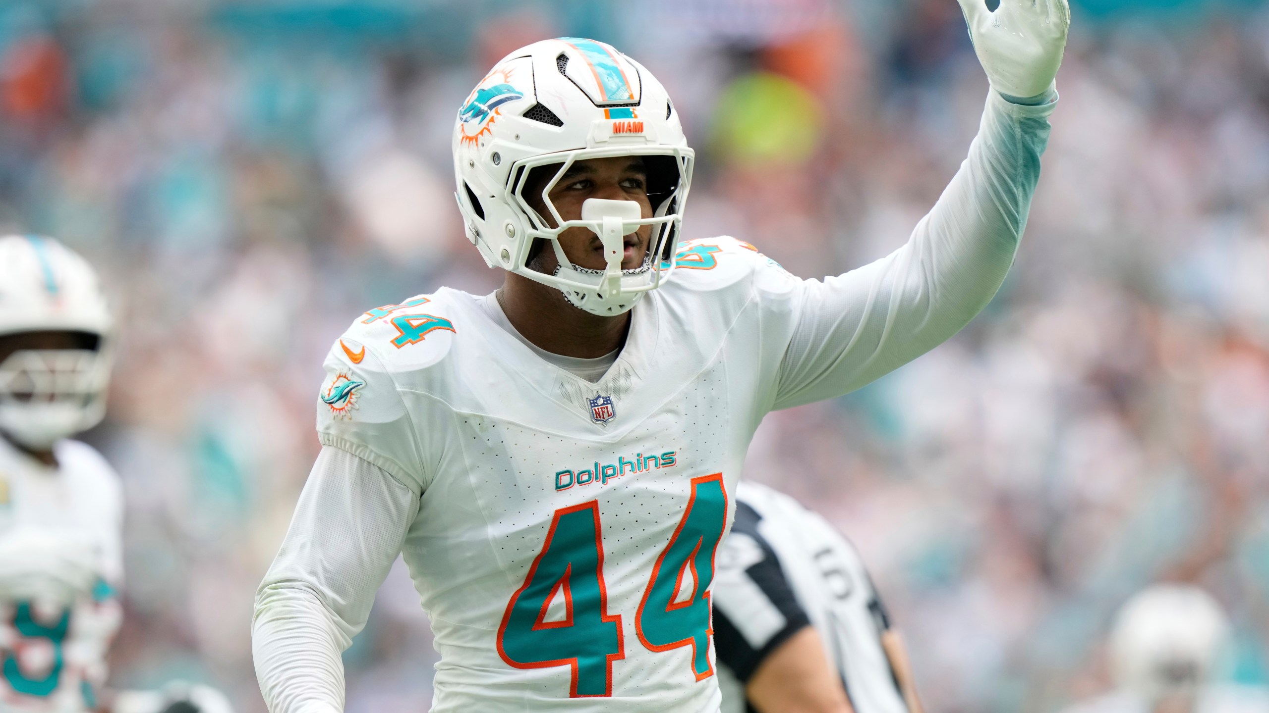 Miami Dolphins linebacker Chop Robinson (44) gestures after sacking New England Patriots quarterback Drake Maye (10) during the first half of an NFL football game, Sunday, Nov. 24, 2024, in Miami Gardens, Fla. (AP Photo/Wilfredo Lee)