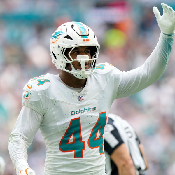 Miami Dolphins linebacker Chop Robinson (44) gestures after sacking New England Patriots quarterback Drake Maye (10) during the first half of an NFL football game, Sunday, Nov. 24, 2024, in Miami Gardens, Fla. (AP Photo/Wilfredo Lee)