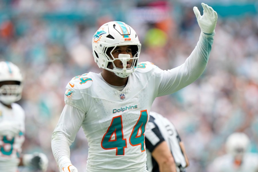 Miami Dolphins linebacker Chop Robinson (44) gestures after sacking New England Patriots quarterback Drake Maye (10) during the first half of an NFL football game, Sunday, Nov. 24, 2024, in Miami Gardens, Fla. (AP Photo/Wilfredo Lee)