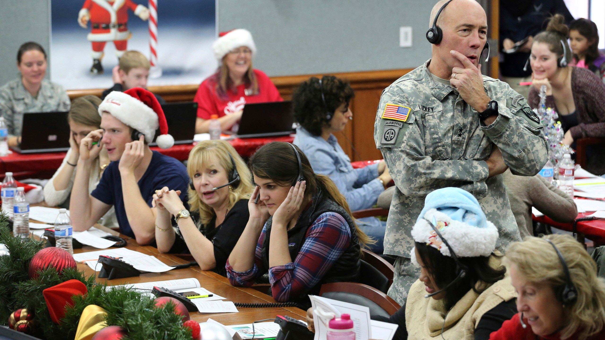 FILE - NORAD Chief of Staff Maj. Gen. Charles D. Luckey takes a call while volunteering at the NORAD Tracks Santa center at Peterson Air Force Base in Colorado Springs, Colo., Dec. 24, 2014. (AP Photo/Brennan Linsley, File)