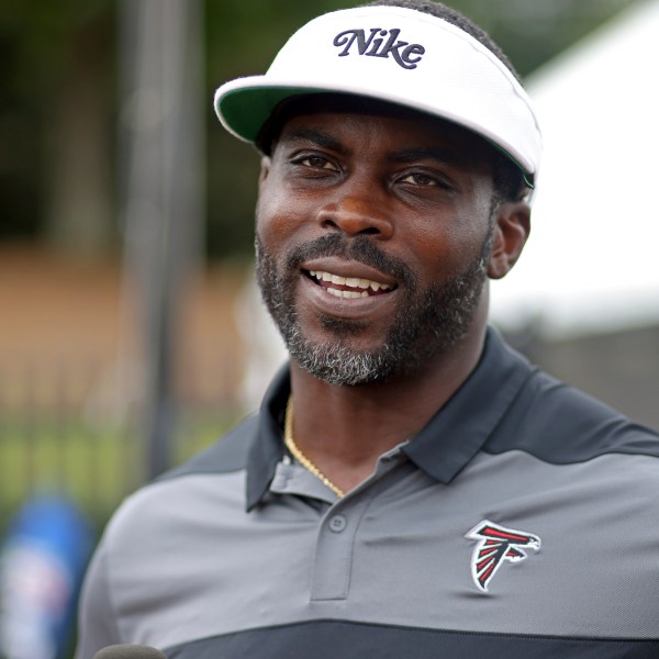 FILE - Former Atlanta Falcons quarterback Michael Vick speaks to members of the media during NFL football training camp at the team's practice facility in Flowery Branch, Ga., Wednesday, Aug. 10, 2022. (Jason Getz/Atlanta Journal-Constitution via AP, File)/Atlanta Journal-Constitution via AP)