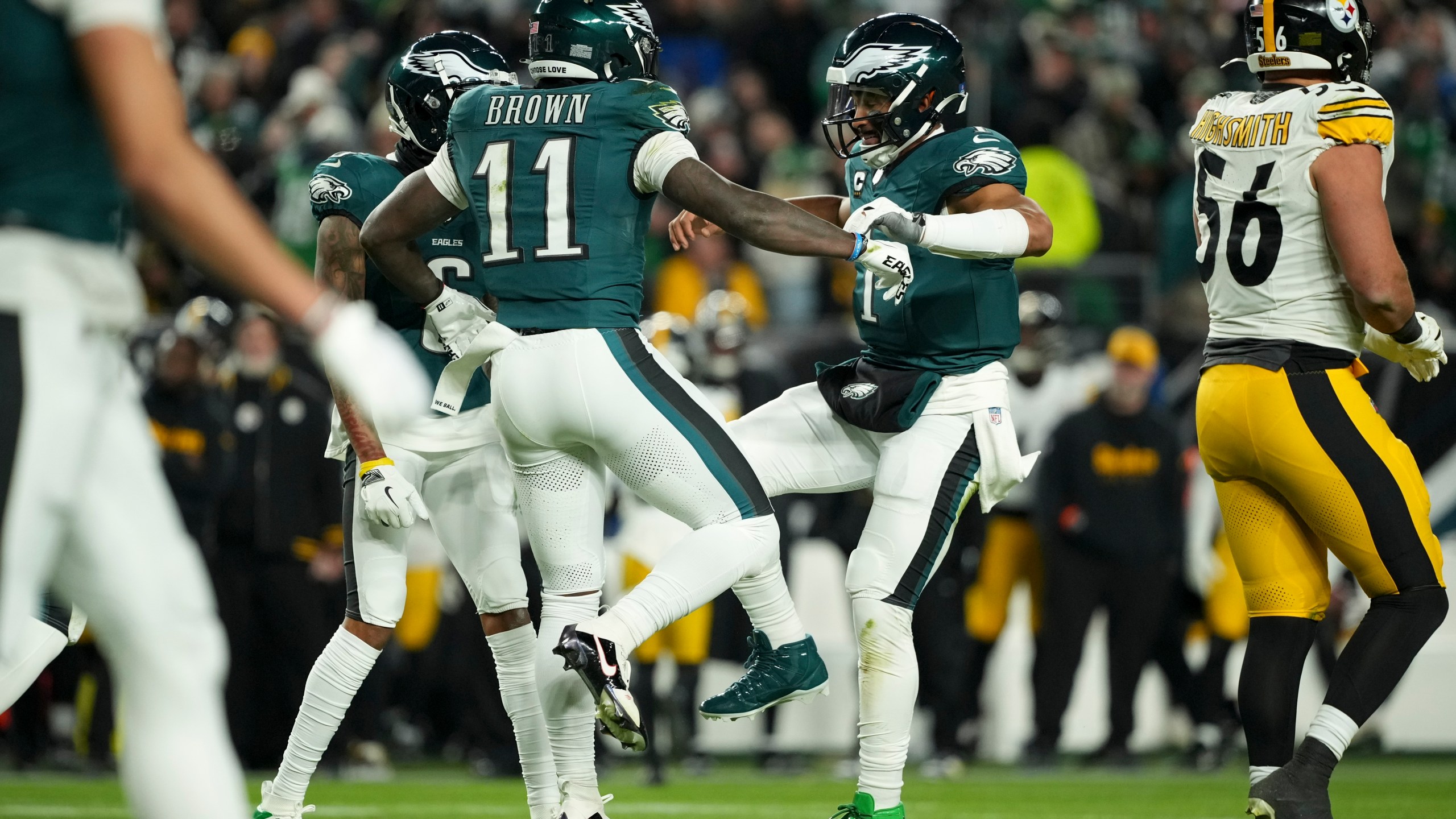 Philadelphia Eagles wide receiver A.J. Brown (11) celebrates his touchdown with teammates Jalen Hurts (1) and DeVonta Smith during the first half of an NFL football game against the Pittsburgh Steelers on Sunday, Dec. 15, 2024, in Philadelphia. (AP Photo/Matt Slocum)