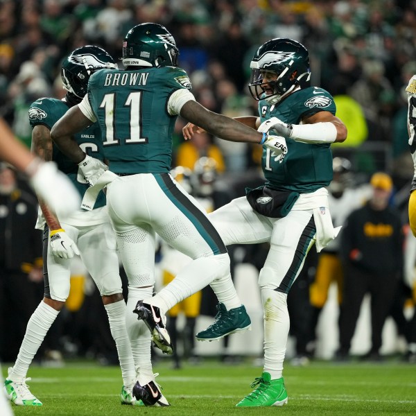 Philadelphia Eagles wide receiver A.J. Brown (11) celebrates his touchdown with teammates Jalen Hurts (1) and DeVonta Smith during the first half of an NFL football game against the Pittsburgh Steelers on Sunday, Dec. 15, 2024, in Philadelphia. (AP Photo/Matt Slocum)